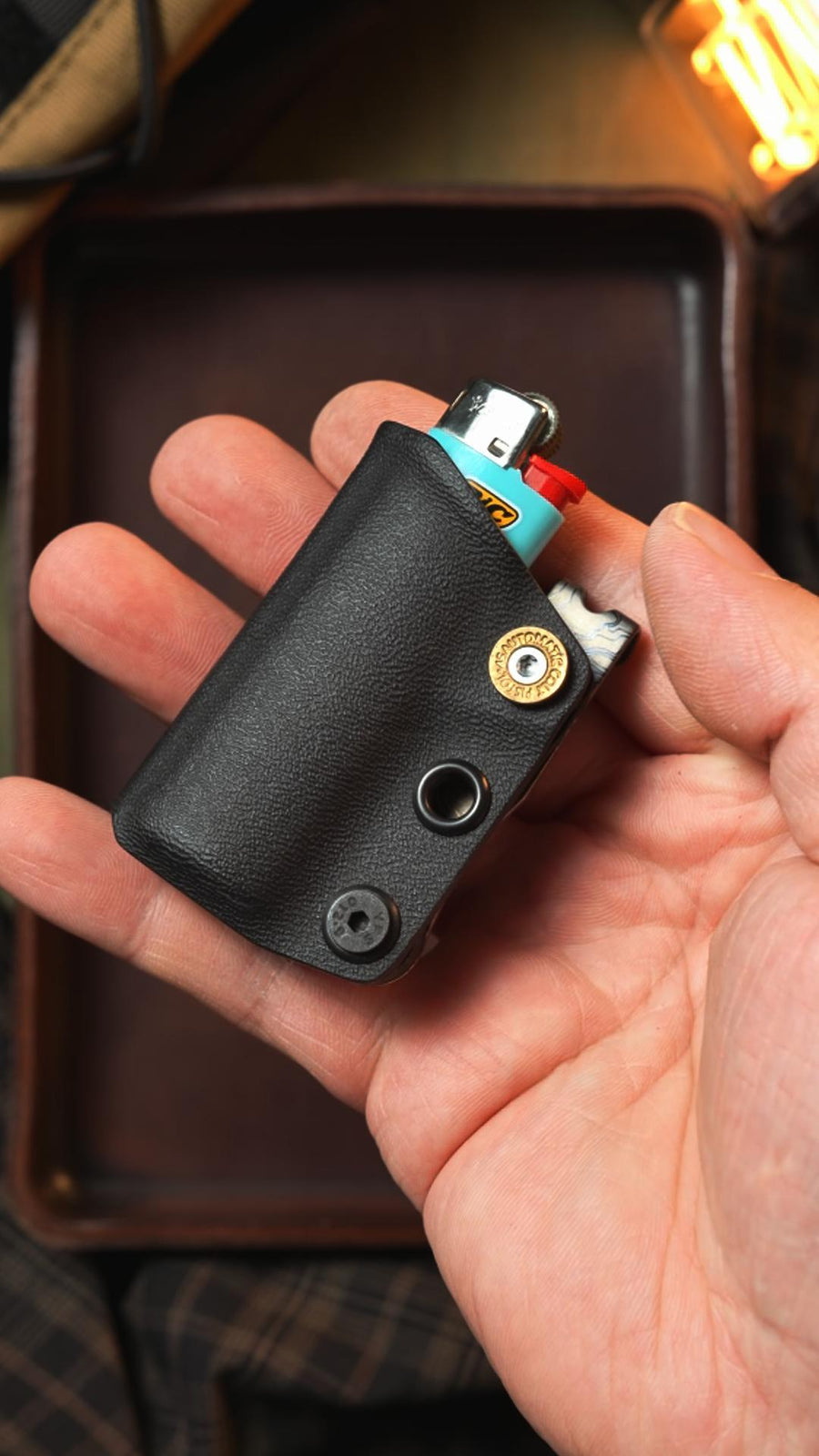 TACTICALGEEK custom Kydex sheath for BIC lighter, shown handheld with customizable color and design options.