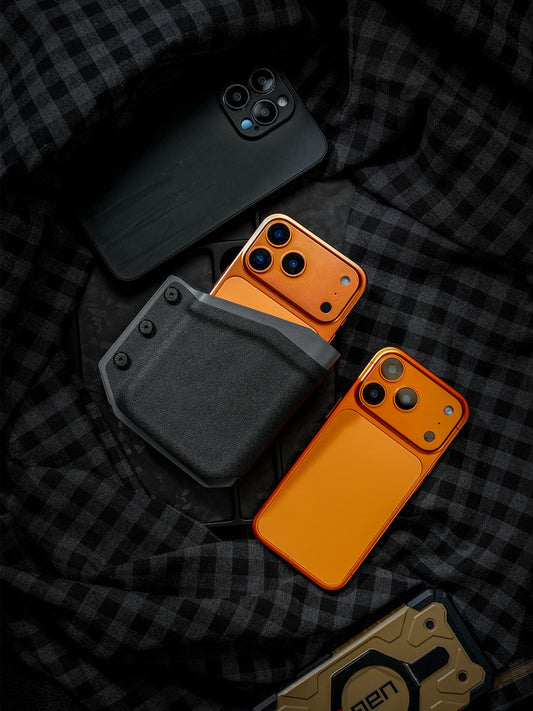 Black-Grey phone case displayed with multiple smartphones, showing the holster holding an orange phone against a dark plaid background.