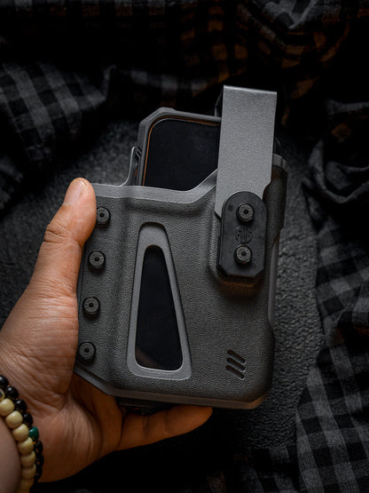 Handheld front view of the black Single Skeleton Window phone case with a smartphone inserted, showing the belt clip and front window design.