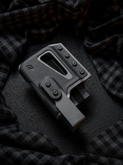 Rear angled view of the black Single Skeleton Window phone case, highlighting the belt clip attachment and overall structure on a dark plaid fabric background.