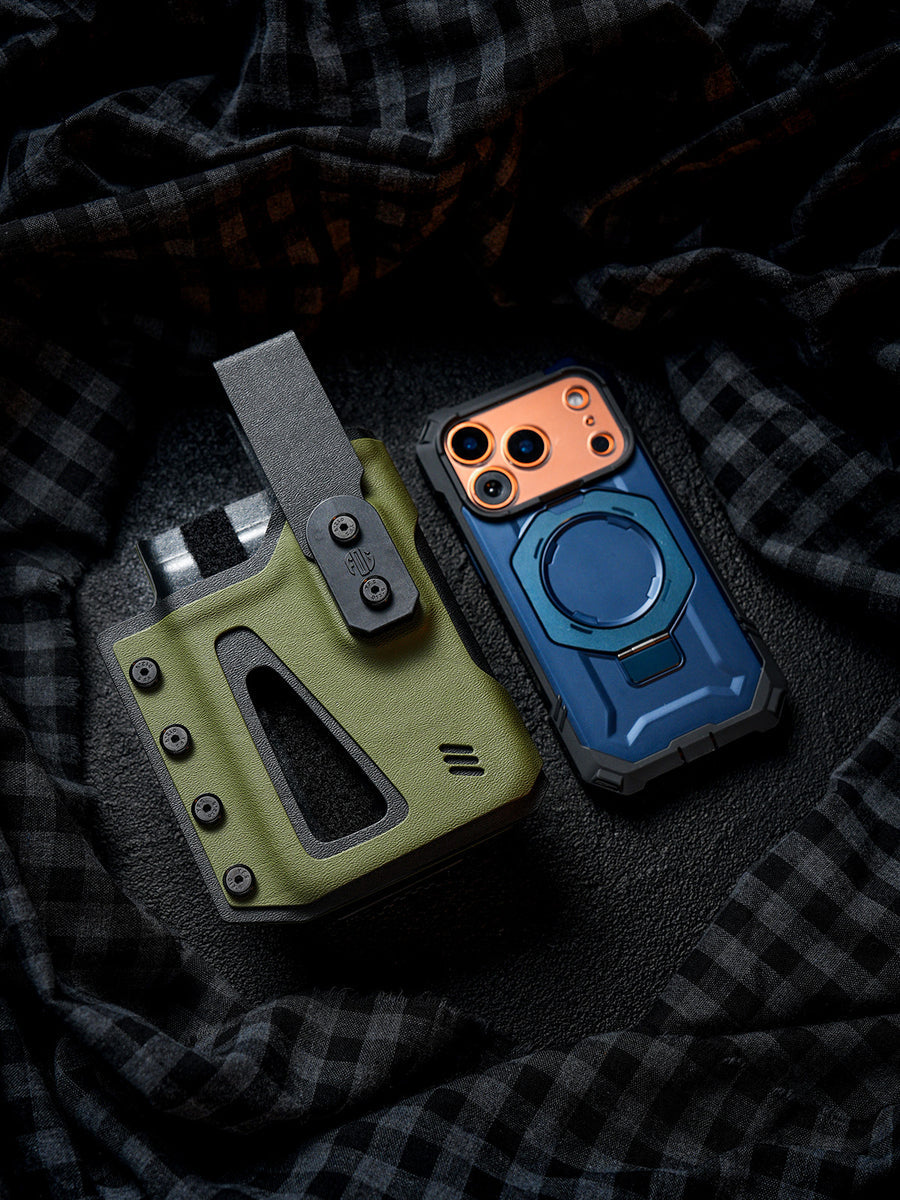 Flat lay of the olive green Single Skeleton Window phone case placed beside a smartphone, showing the front window opening and belt clip design.