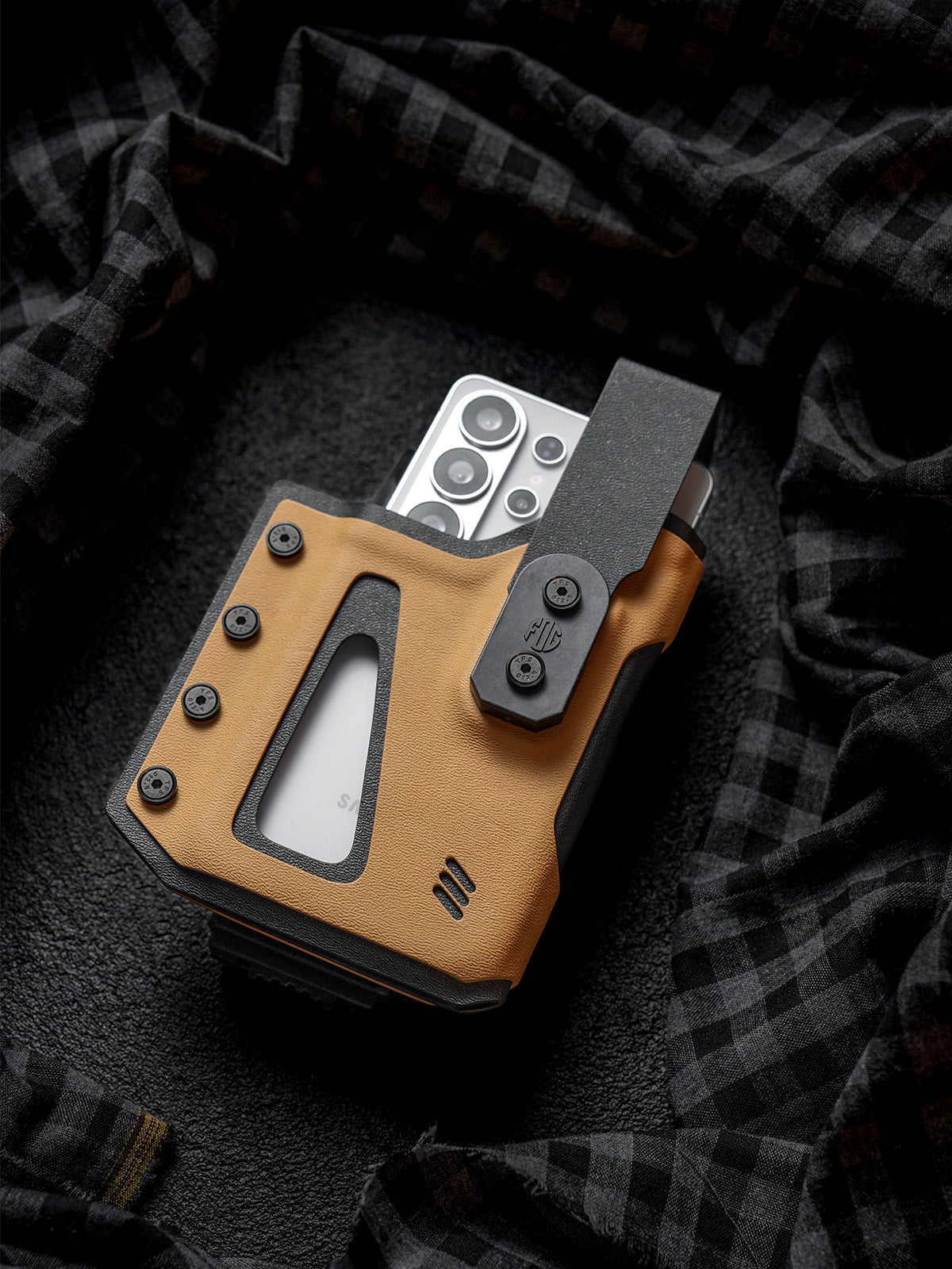 Front view of the tan Single Skeleton Window phone case holding a white smartphone, shown on a dark plaid fabric background.
