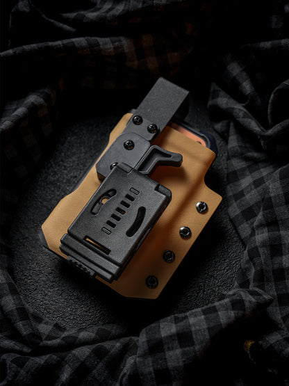 Rear view of the tan Single Skeleton Window phone case with belt clip, shown with a smartphone partially inserted.