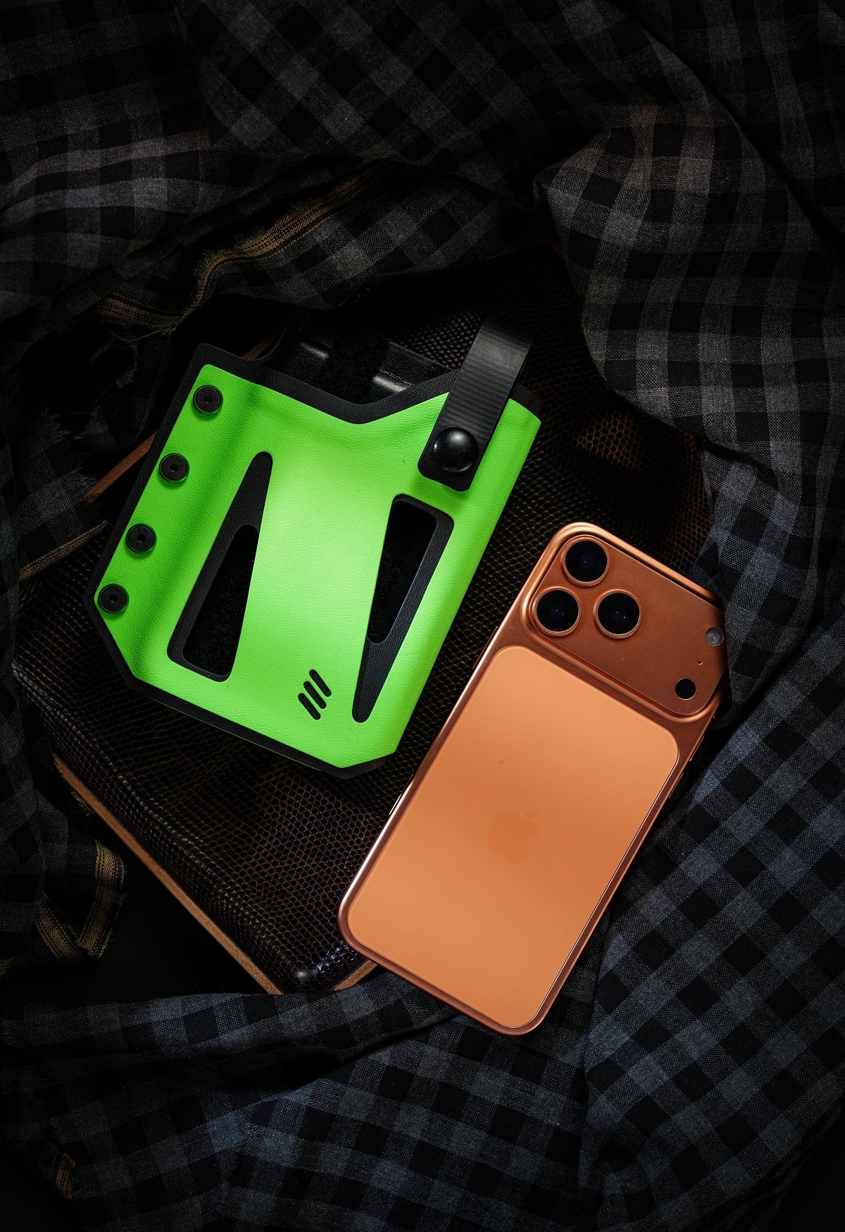 Front view of the neon green Skeleton Frame phone case for iPhone 17 Pro and iPhone 17 Pro Max displayed beside an orange smartphone.