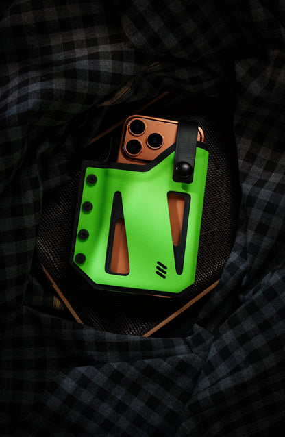 Neon green Skeleton Frame phone case holding an orange smartphone, showing the open-frame design and top retention strap.