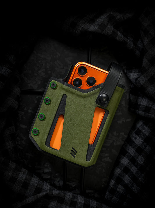 Front view of the olive green Skeleton Frame phone case for iPhone 17 Pro and iPhone 17 Pro Max, holding an orange smartphone with an adjustable retention strap.
