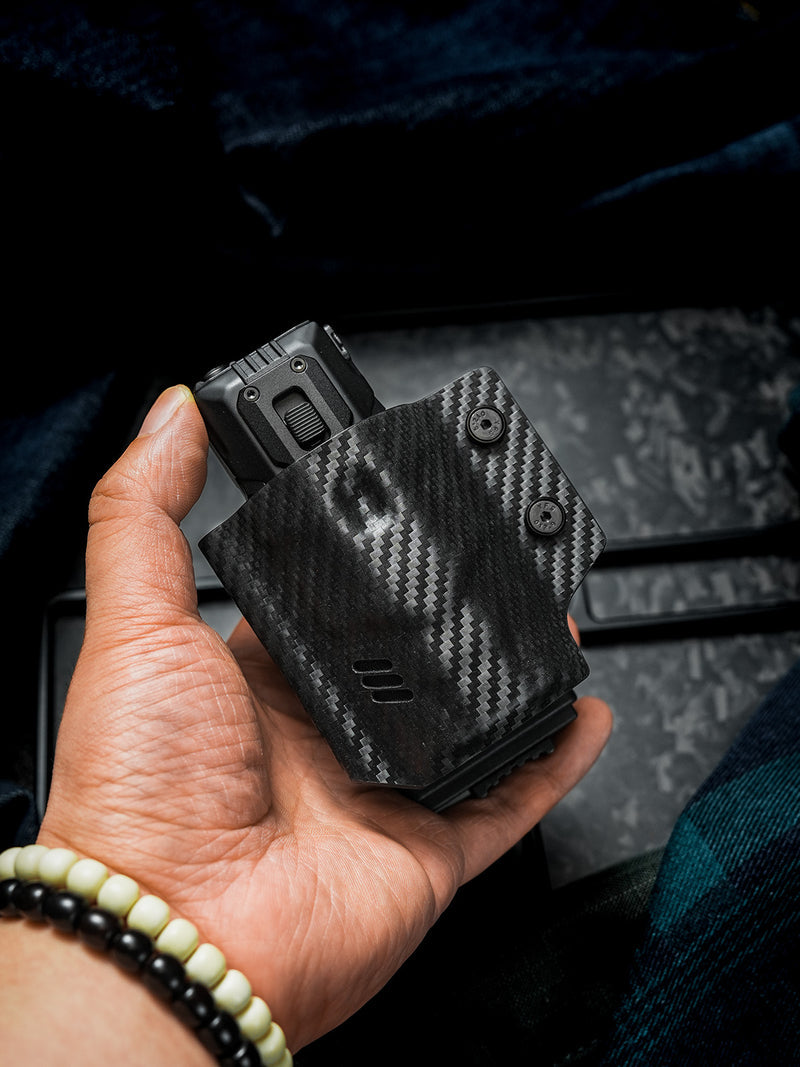 Handheld front view of the carbon fiber texture TACTICALGEEK TG TX13 flashlight sheath for NITECORE EDC37