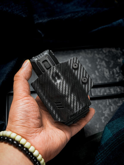 Handheld front view of the carbon fiber texture TACTICALGEEK TG TX13 flashlight sheath for NITECORE EDC37