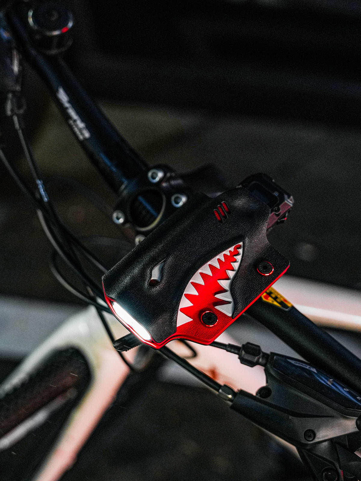 Shark-style TX10 flashlight sheath for Nitecore EDC29 mounted on a bicycle handlebar in an angled view