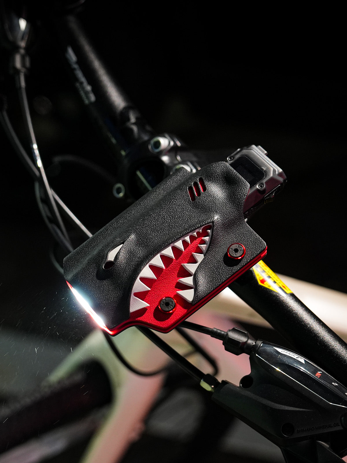 TX10 flashlight sheath for Nitecore EDC29 mounted on a bicycle handlebar, showing the illuminated beam and side profile.