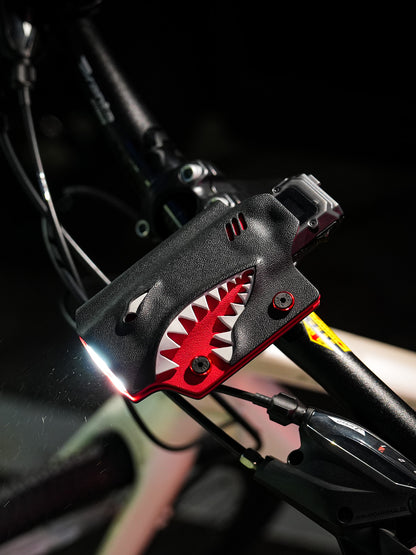 TX10 flashlight sheath for Nitecore EDC29 mounted on a bicycle handlebar, showing the illuminated beam and side profile.