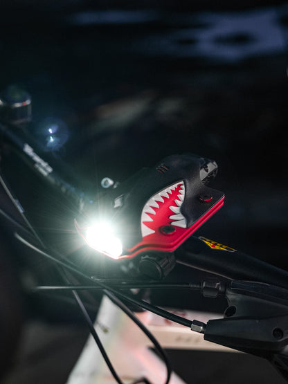 TX10 flashlight sheath for Nitecore EDC29 mounted on a bicycle handlebar clamp with the light turned on.