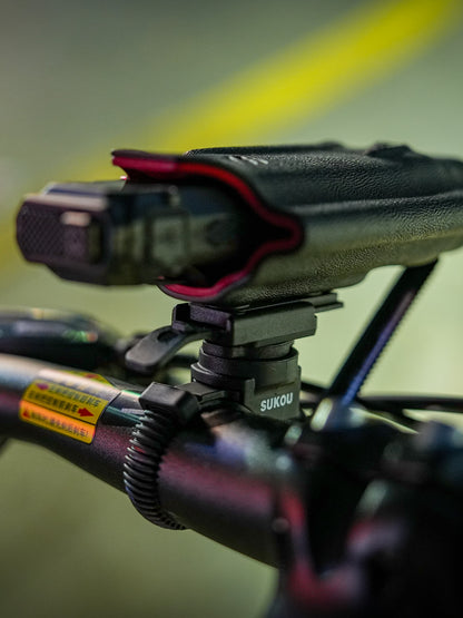 Rear opening view of the TX10 flashlight sheath for Nitecore EDC29 mounted on a removable bicycle clamp.