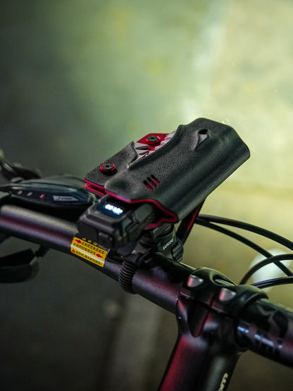 Top view of the shark-style TX10 flashlight sheath for Nitecore EDC29 mounted on a bicycle clamp.