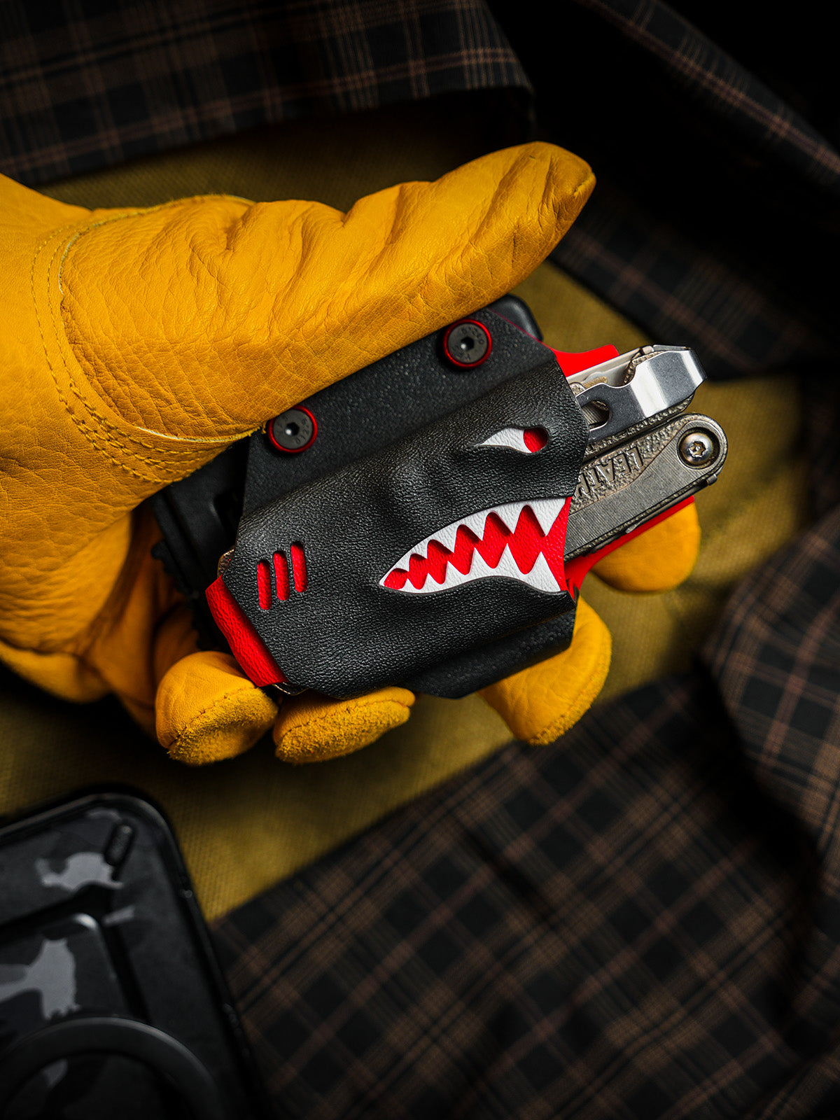 Shark-style TX15 multi-tool sheath for Leatherman Charge with belt clip, handheld front view showing the shark-mouth design.