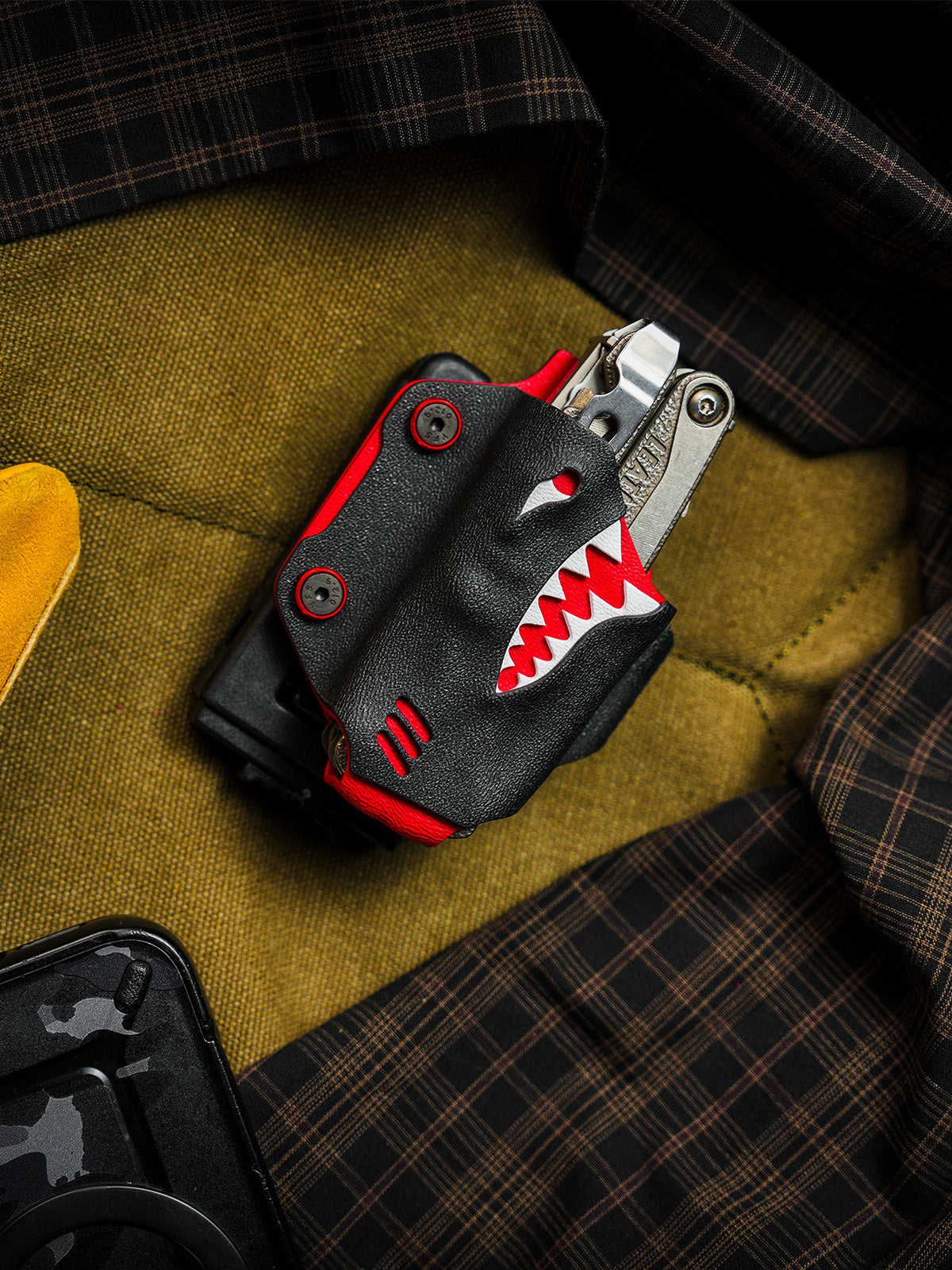 Top view of the shark-style TX15 multi-tool sheath for Leatherman Charge with the multi-tool partially inserted.