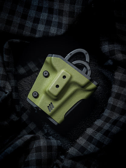 Front view of the TACTICALGEEK TX18 Multi-Tool Sheath for SOG ParaShears in green colorway, showing the molded front panel and exposed ParaShears handles.