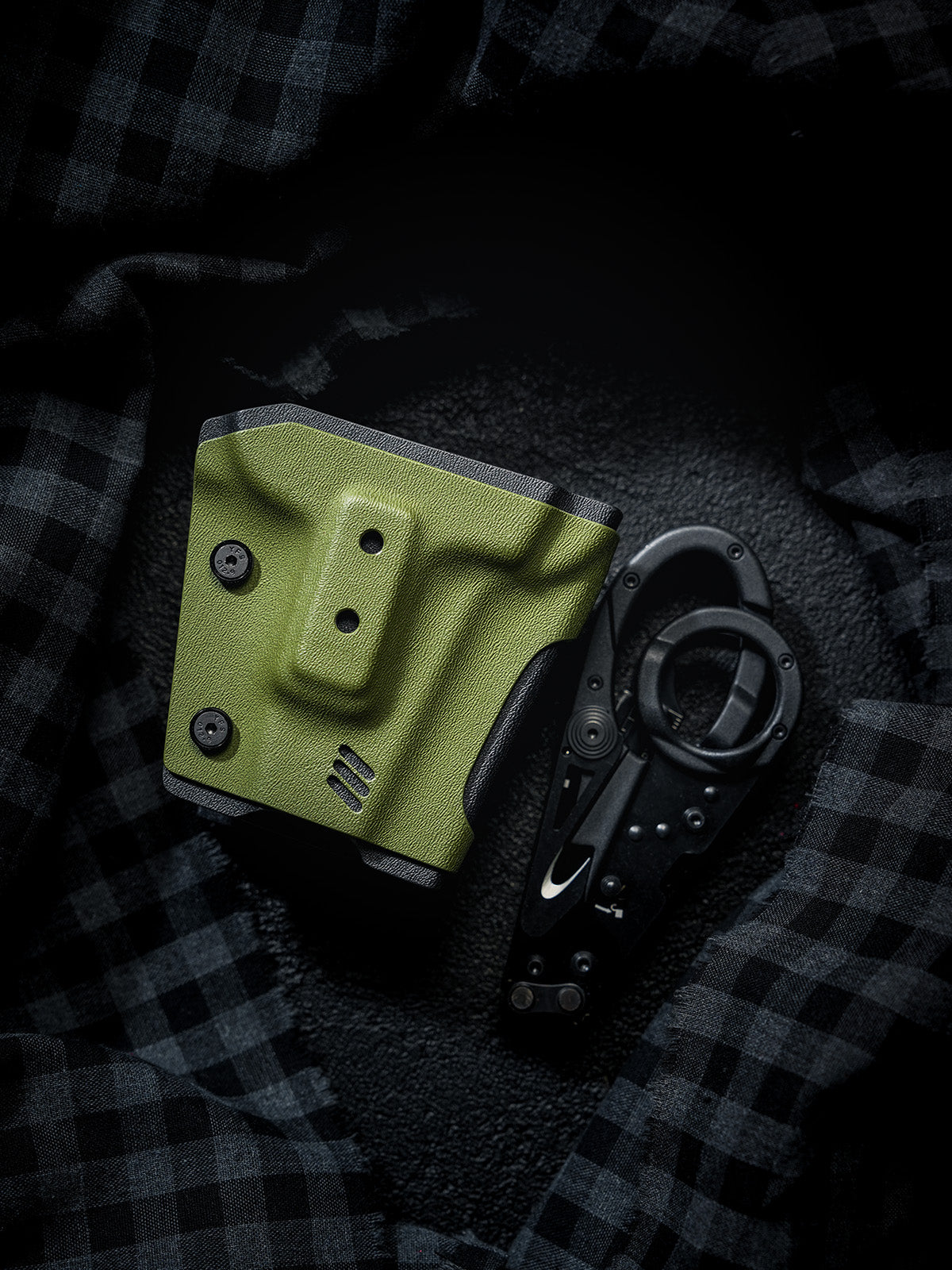 TACTICALGEEK TX18 Multi-Tool Sheath for SOG ParaShears in green colorway displayed beside the SOG ParaShears tool on a dark fabric background.