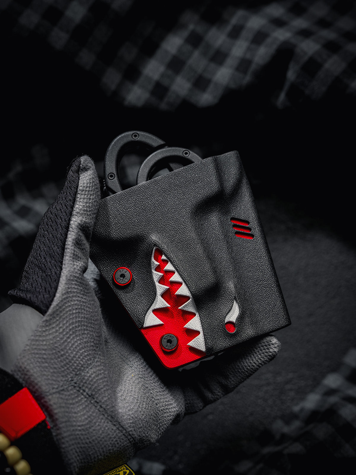 Handheld view of the TACTICALGEEK TX18 Multi-Tool Sheath for SOG ParaShears in shark colorway, showing the shark-style front design.