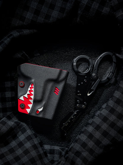 TACTICALGEEK TX18 Multi-Tool Sheath for SOG ParaShears in shark colorway with the tool partially extended, displayed on dark fabric.