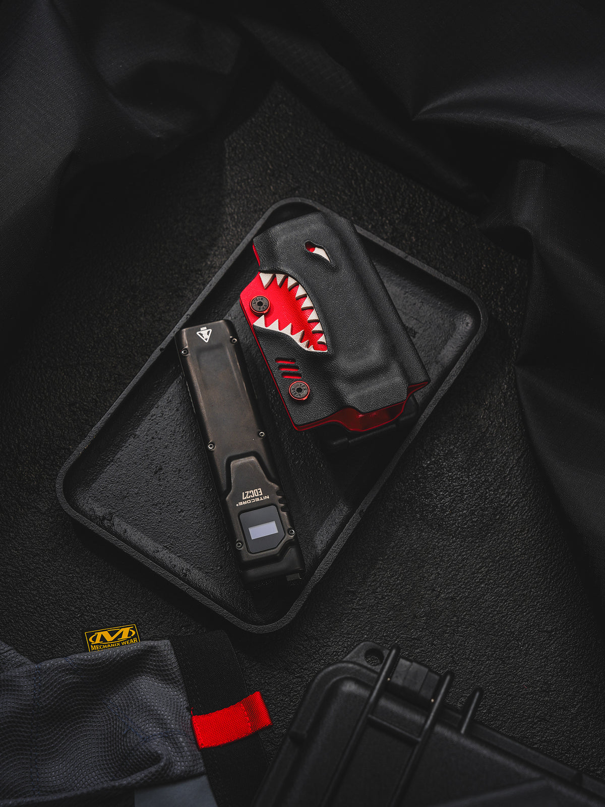 TACTICALGEEK TX9 flashlight sheath for Nitecore EDC27 shown with the flashlight removed and placed beside the sheath.