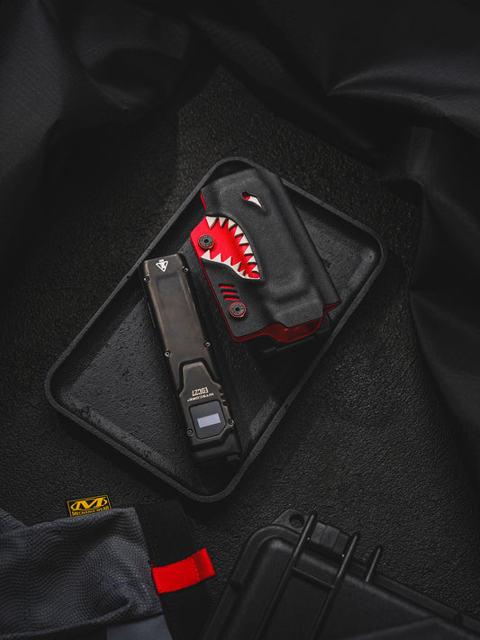 TACTICALGEEK TX9 flashlight sheath for Nitecore EDC27 shown with the flashlight removed and placed beside the sheath.