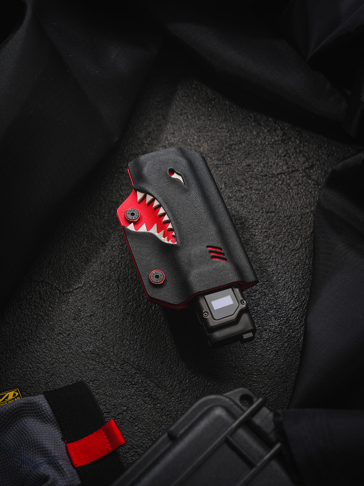 TACTICALGEEK TX9 flashlight sheath for Nitecore EDC27 in an angled front view highlighting the shark-mouth design.