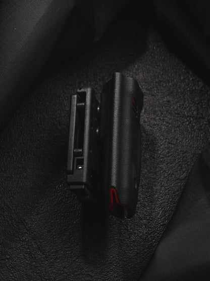 TACTICALGEEK TX9 flashlight sheath for Nitecore EDC27 slim side profile on a dark textured background.