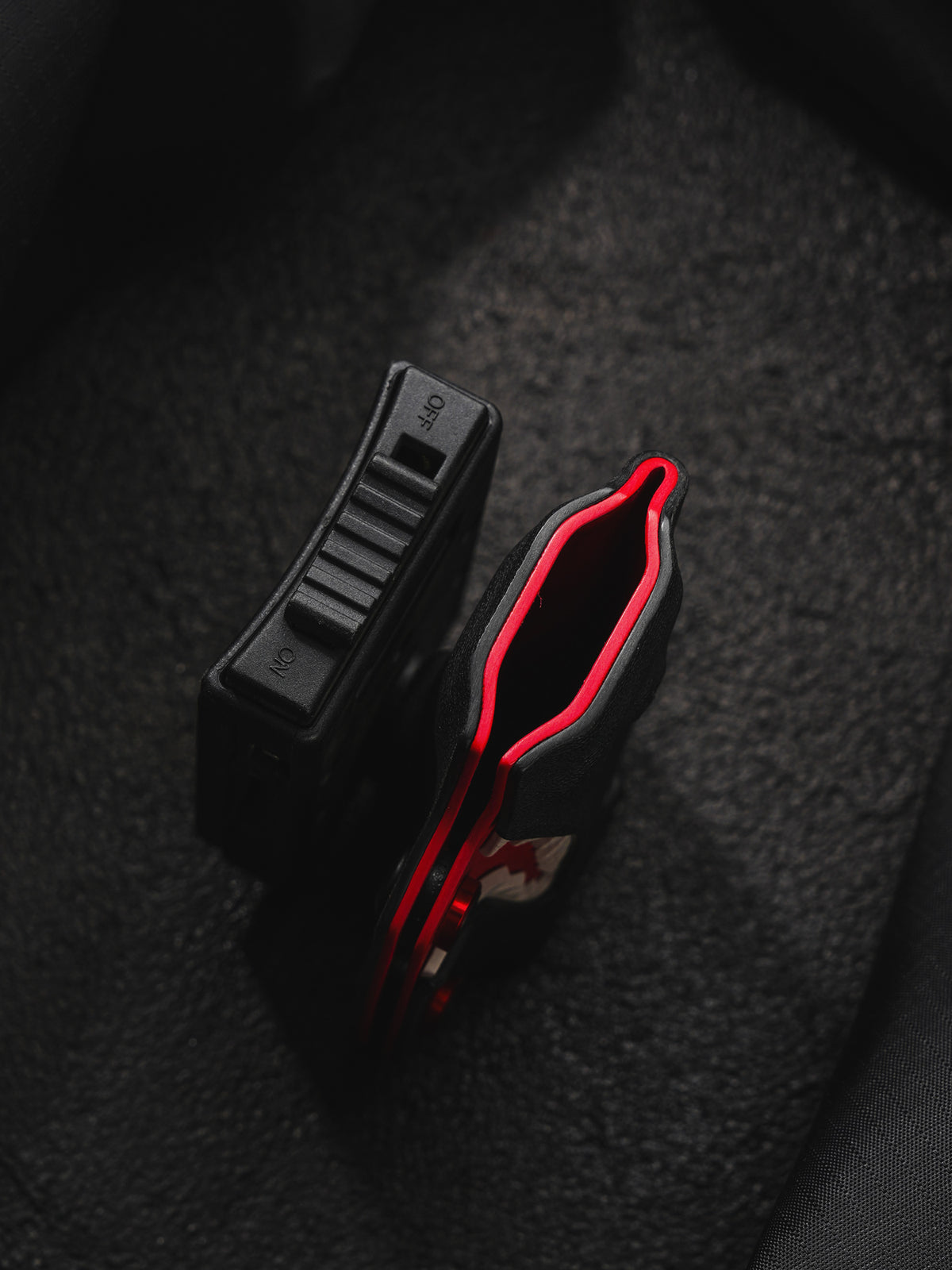 TACTICALGEEK TX9 flashlight sheath for Nitecore EDC27 top view with visible clip and ON/OFF switch detail.