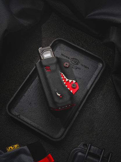 TACTICALGEEK TX9 flashlight sheath for Nitecore EDC27 displayed on a black tray with shark-style front detail.