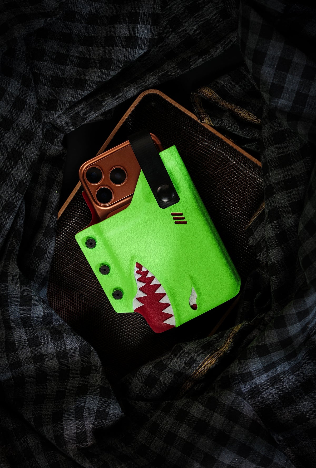Front display of the neon green TACTICALGEEK TG EDC KYDEX shark phone sheath for iPhone 17 Pro with black snap strap.