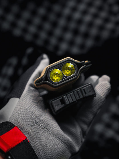 Top detail of the sand-colored TX10 Flashlight Sheath showing the flashlight lenses and the detached belt clip in hand.