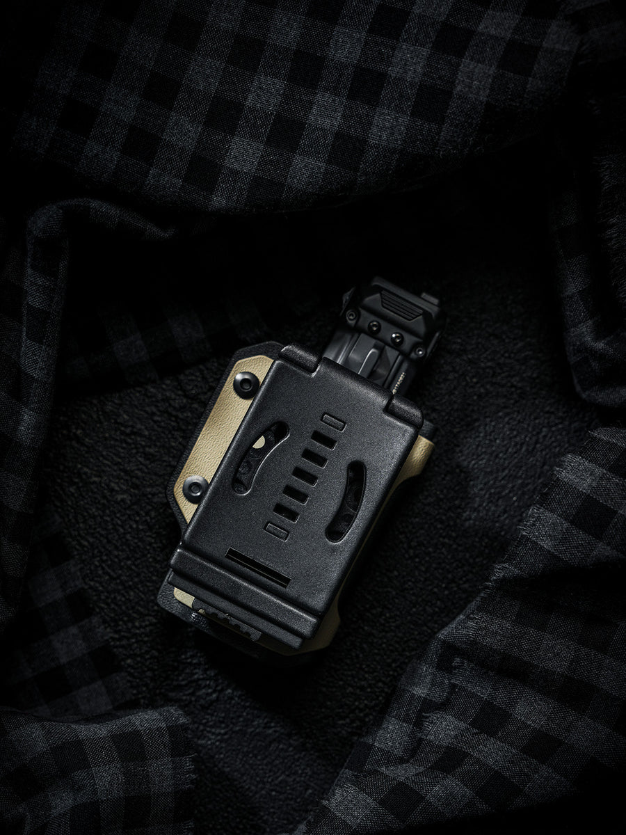 Rear view of the sand-colored TX10 Flashlight Sheath showing the back clip with a Nitecore EDC29 flashlight inserted.