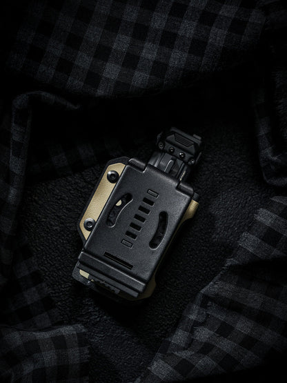 Rear view of the sand-colored TX10 Flashlight Sheath showing the back clip with a Nitecore EDC29 flashlight inserted.