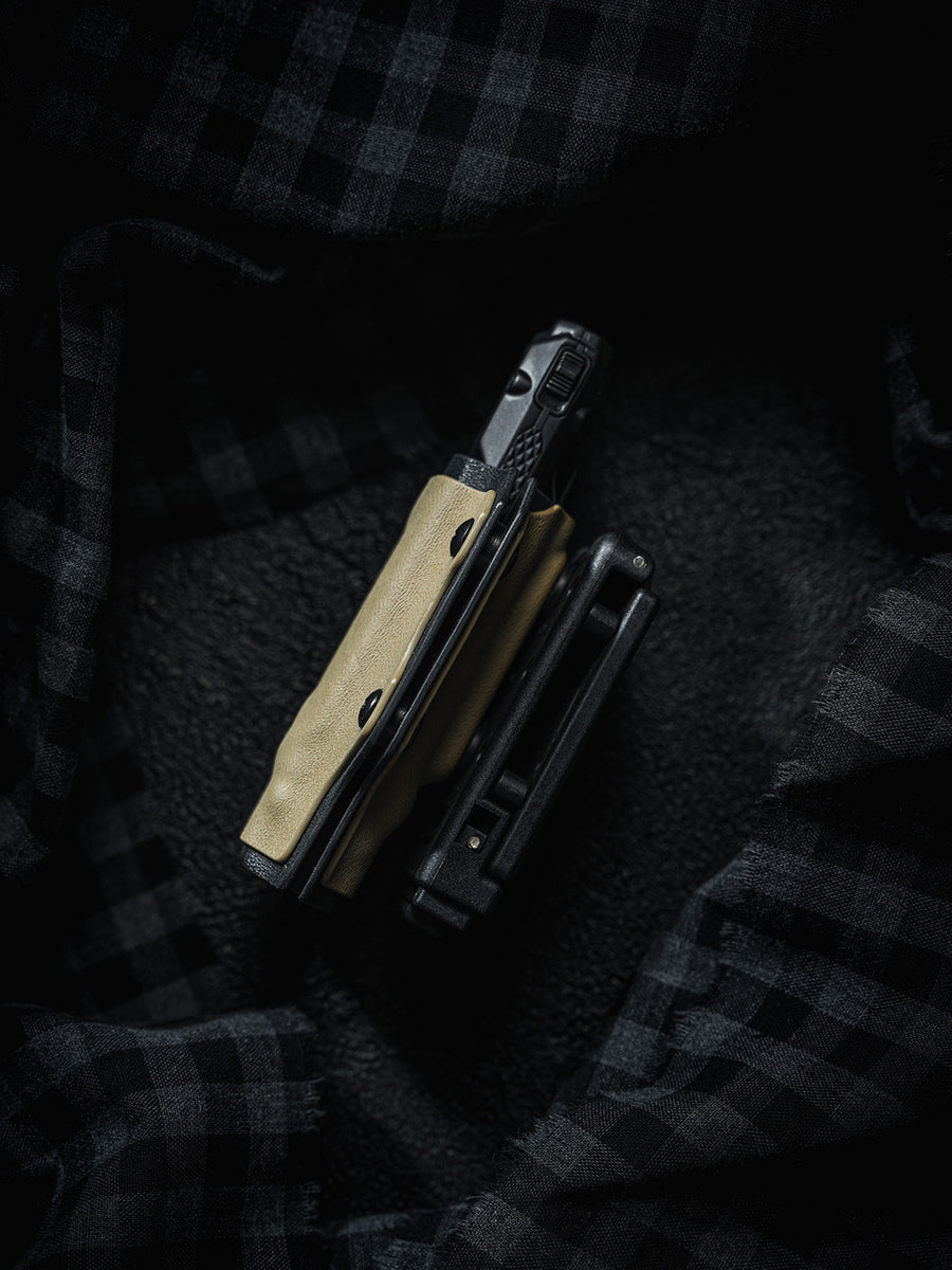 Side view of the sand-colored TX10 Flashlight Sheath with a Nitecore EDC29 flashlight inserted and the belt clip shown beside it.