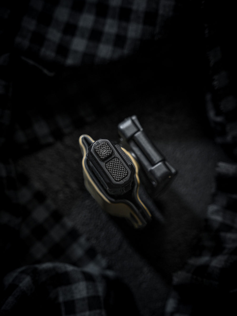 Top-down close-up of the sand-colored TX10 Flashlight Sheath showing the flashlight tail controls and the detached clip.