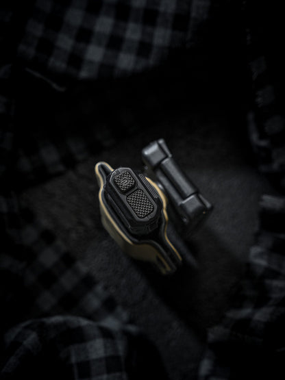 Top-down close-up of the sand-colored TX10 Flashlight Sheath showing the flashlight tail controls and the detached clip.