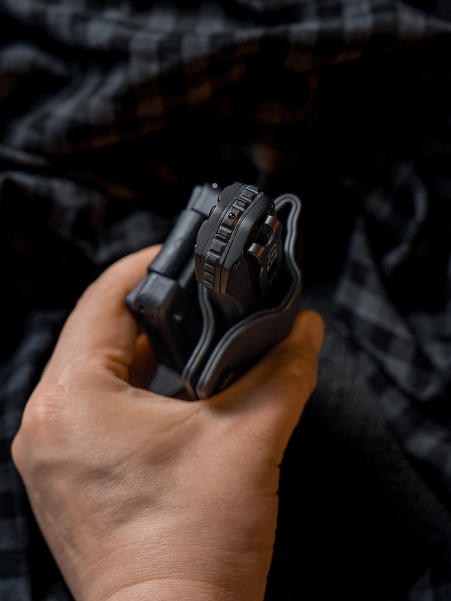 Close-up handheld view of the TX17 flashlight sheath for Nitecore EDC17, showing the flashlight seated inside the sheath and the top opening detail.