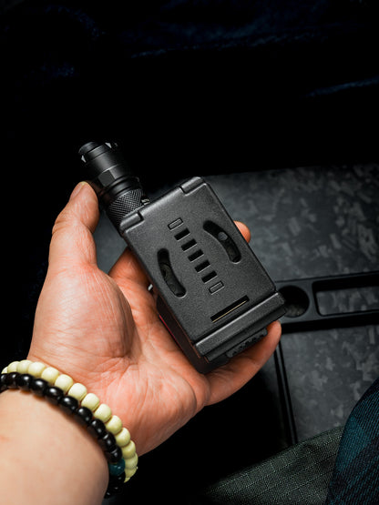 Hand holding the back side of the TX22 flashlight sheath for Nitecore P20ix, highlighting the black belt clip and compact carry design.