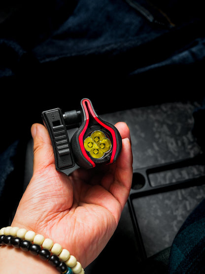 Top view of the TX22 shark-style sheath holding a Nitecore P20ix flashlight, showing the flashlight tailcap and the belt clip from above.
