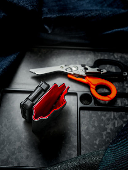 Open-top view of the TX24 shark multi-tool sheath for Leatherman Raptor, showing the red interior and belt clip attachment.